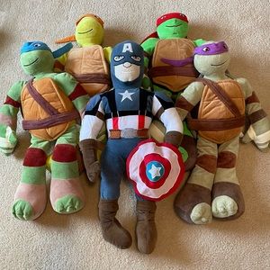 Large Teenage Mutant Ninja Turtle and Captain America plush toys.